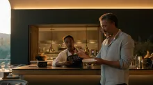 A late-night restaurant customer holds an empty plate while a chef behind the counter displays a CLOSED sign beside a clock showing 23:00.
